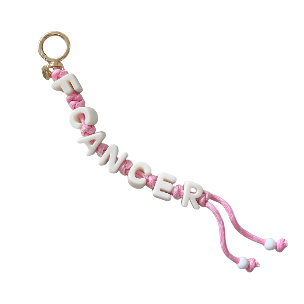 Pink and white 'F CANCER' charm on a white background