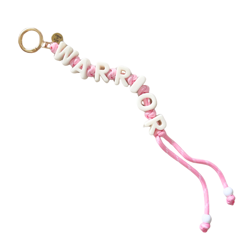 Pink keychain with 'WARRIOR' letters on a white background