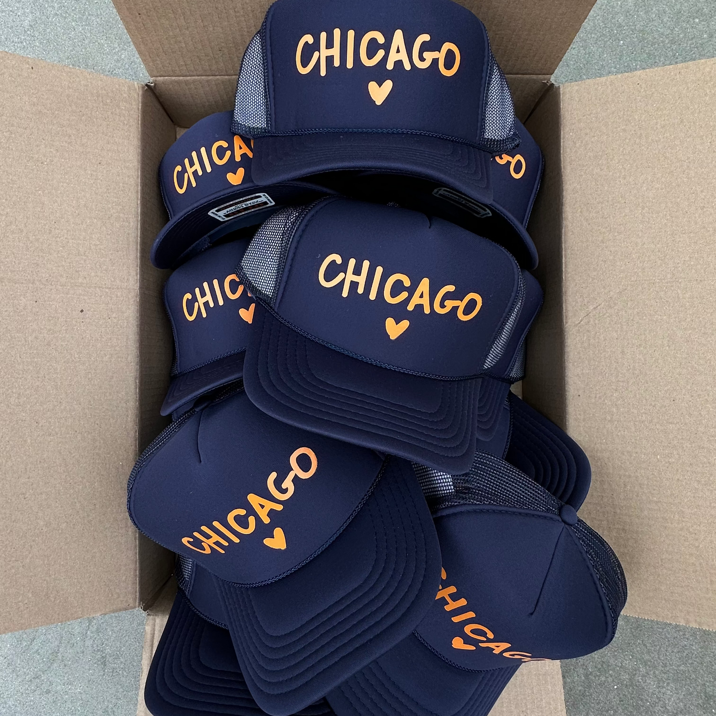 Navy blue protective gear with 'Chicago' branding in a cardboard box.